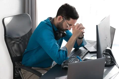 Middle-aged man working at home. Headache. Hand on nasal septum Stock Photos