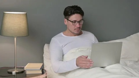 Middle Aged Man working on Laptop in Bed Video stock 142369581