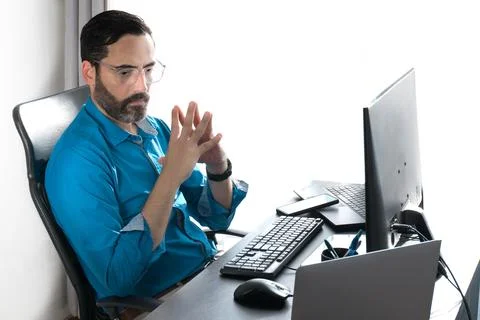 Middle-aged man working online in home office Stock Photos
