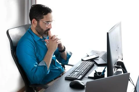 Middle-aged man working online in home office Stock Photos