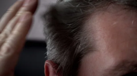 Middle aged man worried about grey hairs Stock Footage 55756828