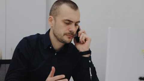 Middle aged manager with a tired face talking on the phone Stock Footage 106498432
