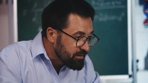Middle-aged math teacher conducting private online class, working from home Stock Footage 313493637