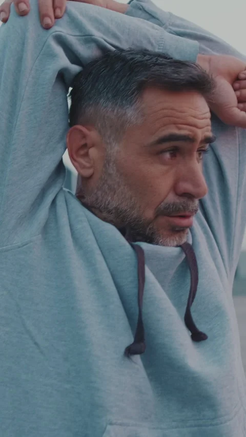 Middle-aged men doing warm-up before exercise outdoors Stock Footage 255963622