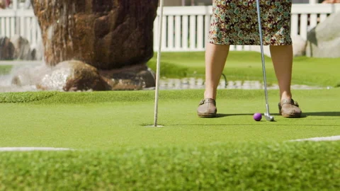 Middle aged mom on vacation flower patterned dress and shoes putting Video stock 150644532