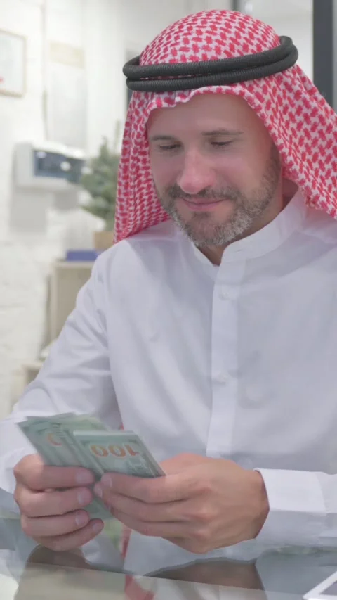 Middle Aged Muslim Man Counting Money at Work, vertical video Video stock 324777517