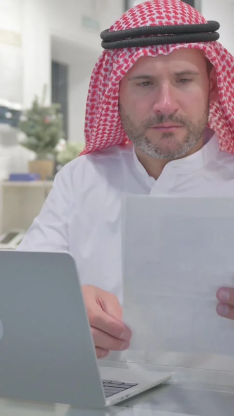 Middle Aged Muslim Man Doing Multitasking at Work, vertical video Stock Footage 324777475