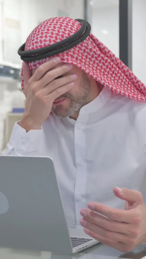 Middle Aged Muslim Man Feeling Upset while Doing Multitasking at Work, vertical Stock Footage 324777448