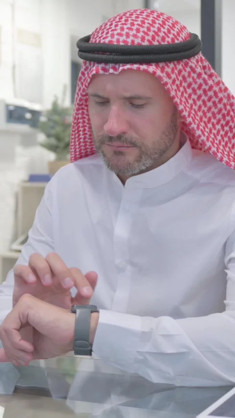 Middle Aged Muslim Man Using Smart watch in Office, vertical video Stock Footage 324777565