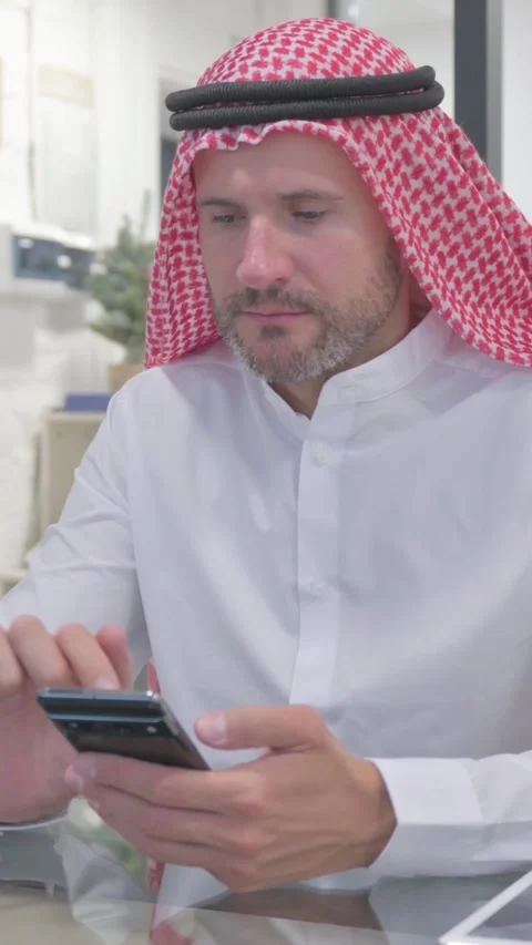 Middle Aged Muslim Man Working on Smartphone in Office, vertical video Video stock 324777532