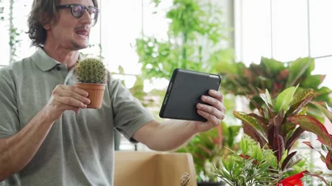 Middle aged or mature man planting and selling tree online, Aging society  Stock Footage 139744323