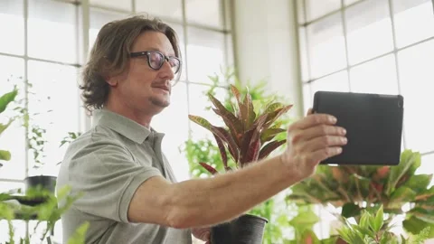 Middle aged or mature man planting and selling tree online, Aging society  Stock Footage 139744357
