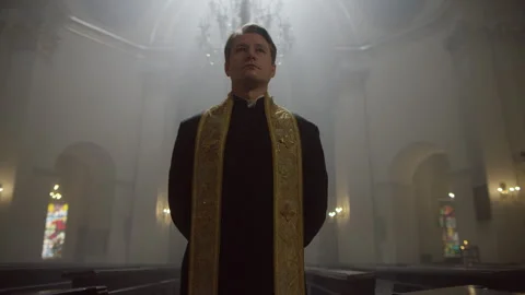 A middle aged priest in the church Stock Footage 283257901
