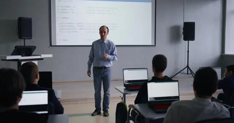 Middle-Aged Professor Of Computer Science And Programming Teaching Young School Stock Footage 280640066