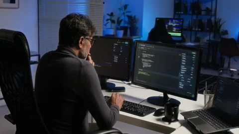 Middle Aged Programmer Analyzing Code on Computer in Night Office Stock-Footage 347306092