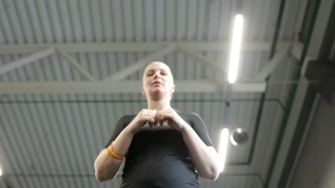 Middle-aged redhead is engaged in the gym and trains the abdominal press, bottom Stock Footage 202341704