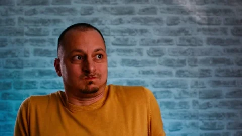 Middle aged scared man shouting loud isolated over neon blue background. Video stock 147948267