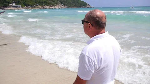 Middle-Aged Senior Man Walking on Beach in Summer in Sea Vidéo 75307135
