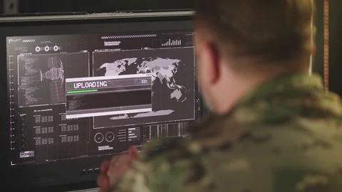 Middle-aged service member uploading satellite intelligence data on computer Stock Footage 335538137