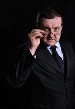 Middle aged solid man dressed in suit studio portrait Stock Photos