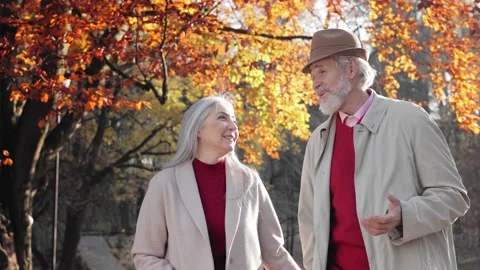 Middle aged spouses enjoying time together in beautiful autumn park. Happy old 스톡 동영상 167389754