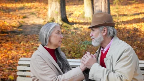 Middle aged spouses enjoying time together in beautiful autumn park. Happy old Stock Footage 202180952