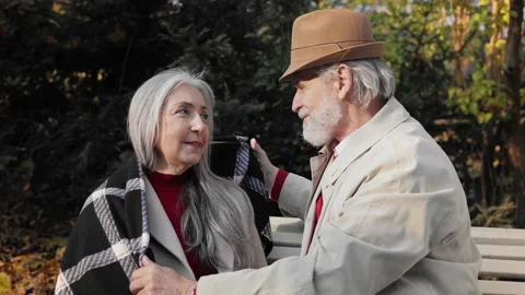 Middle aged spouses enjoying time together in beautiful autumn park. Happy old Stock Footage 205085274