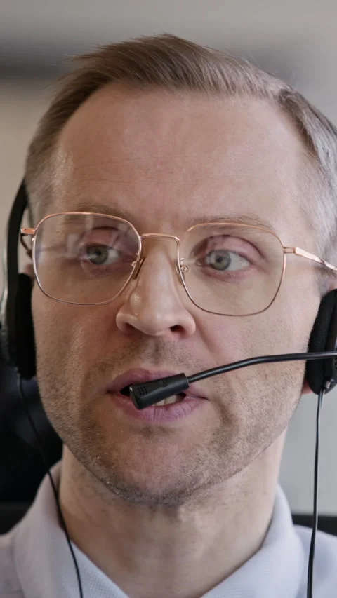 Middle-aged Support Agent in Headset Consulting Customer in Call Center Stock Footage 335748792
