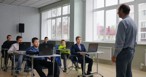 Middle-Aged Teacher And Group Of Schoolboys In Computer-Based Class, Education Stock Footage 280173310