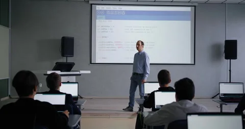 Middle-Aged Teacher Speaking In Classroom With School Students, Coding and Stock Footage 280173335