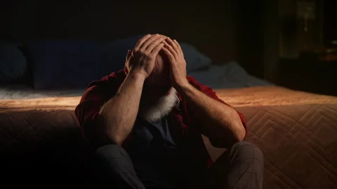 Middle-aged widower cries while sitting on floor, coping with grief and loss Stock Footage 346714230