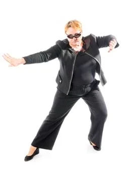 Middle aged woman in black jacket and trousers dancing an emotional dance Stock Photos