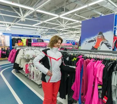 Middle-aged woman chooses clothes in  sports shop Stock Photos