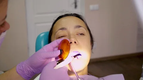 Middle-aged woman at the dentist while treatment process at the dental clinic, w Stock Footage 118712852