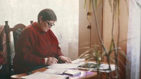 A middle-aged woman does work at home Stock Footage 204789467