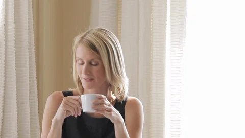 Middle-aged woman drinking a cup of tea. Stockbeeldmateriaal 88369219
