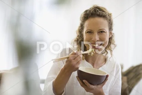Middle-aged woman eating healthy food Stock Photos