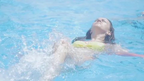 A middle-aged woman in the pool does water aerobics. Stock Footage 84273442