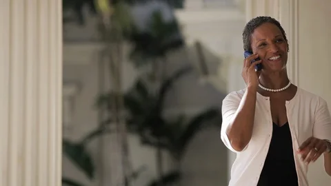 Middle-aged woman smiling on a phone call. 스톡 동영상 88368853