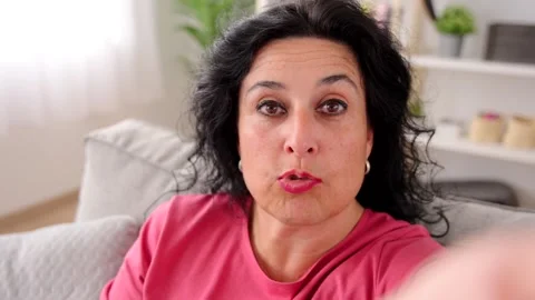 Middle aged woman talking to camera Stock Footage 249728656