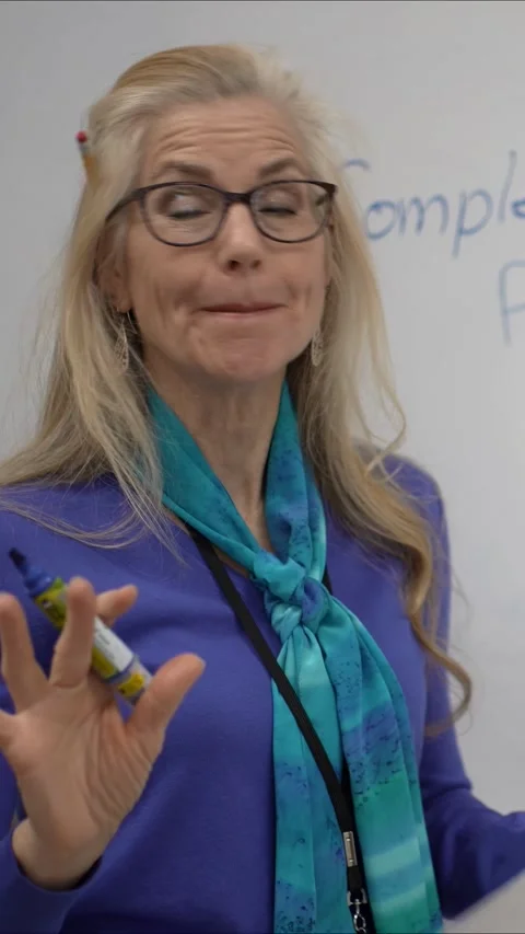 Middle-aged Woman Teaching Complex Biology Patterns in a Classroom Setting Stock Footage 306329960