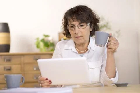 A middle-aged woman using a  computer tablet Stock Photos