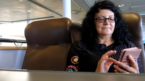 Middle aged woman using mobile phone inside of ferry 動画素材 126889178