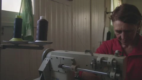 Middle-aged Woman using sewing machine Stock Footage 275076002