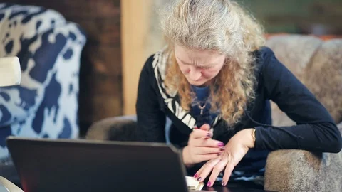 Middle-aged woman working on a computer Stock Footage 98590474