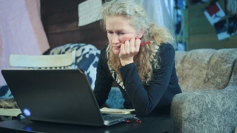 Middle-aged woman working on a computer Stock Footage 98590887