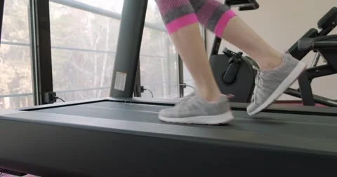 Middle aged woman working on treadmill, gym workout. Girl is working out at gym Stock-Footage 276051953