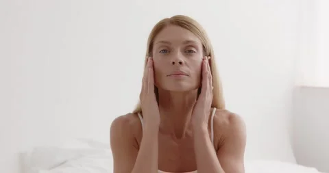 Middle aged woman's face with perfect skin. Older mature lady touching pampering Stock Footage 205088678