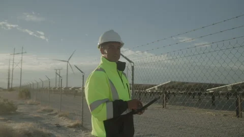 Middle Aged Worker Uses Touch Screen Device at Green Energy Desert job site Stock Footage 211869396