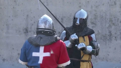 Middle Ages art of fighting. Two men dressing metal armor fight a duel. Slomo. Stock Footage 76252276